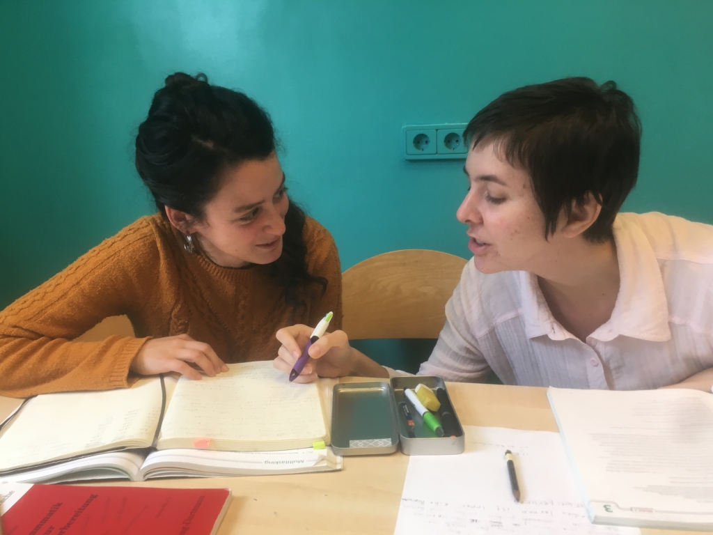 Learn to write German; students working together in class
