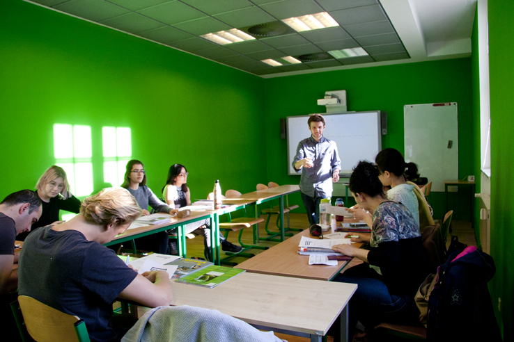 german classes Berlin; teacher and students in a classroom of deutSCHule